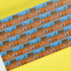 A close-up of a custom ticket book on a yellow surface.