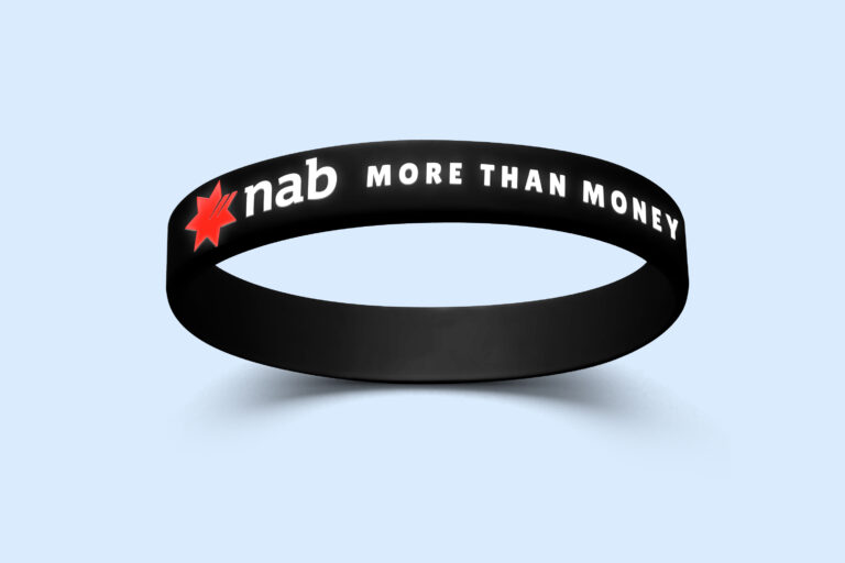 A silicone wristband featuring the NAB logo and the phrase 'NAB - More than money'