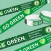 A collection of eco-friendly green and white "Go-Green" wristbands displayed against a green background.